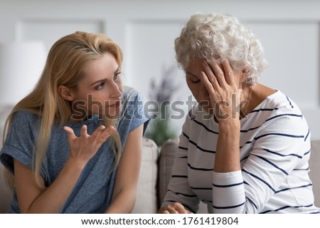 Family sit on couch having dispute, grown up daughter proves her right aggressively argue with elderly mother, 60s mom in despair due to misunderstanding. Generational gap, conflicts at home concept Royalty-Free Stock Photo #1761419804
