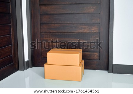 A parcel box placed at the front of the door. Quarantine, contactless delivery during a pandemic covid. Stay at home, Online shopping. Royalty-Free Stock Photo #1761454361