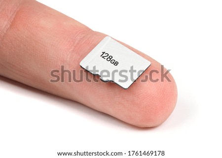 SD memory card on finger isolated on white background. High resolution photo. Full depth of field.