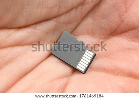 SD memory card isolated on hand. High resolution photo. Full depth of field.