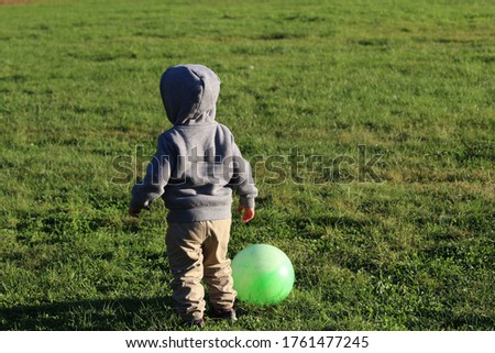Picture of baby boy play in the park.