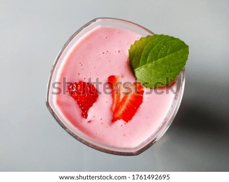 Strawberry cocktail with strawberries and mint. Grey background. 