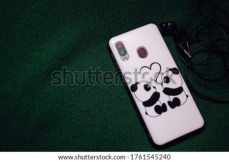 Telephone with earphone and case cover cartoon on a green background