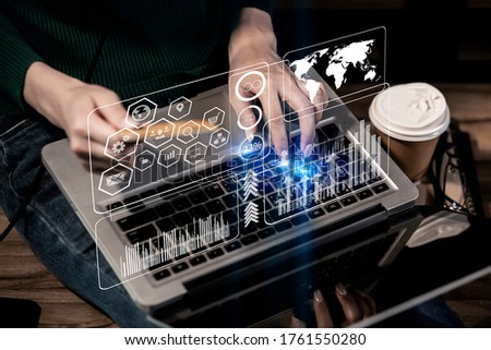 Young woman hands holding plastic credit card and using laptop. Online shopping concept. Network connection on virtual screen, Background toned image blurred.