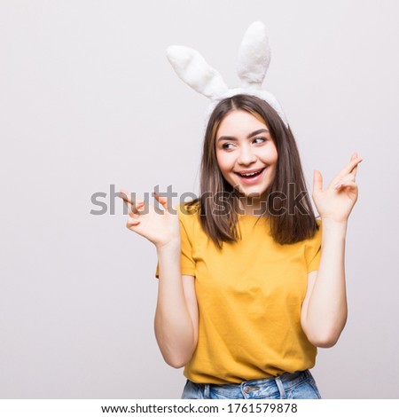 Portrait of pretty girl with funny bunny ears isolated white background.