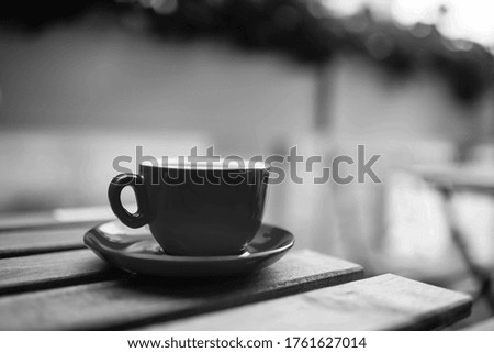 Hot coffee with latte art in a cup with saucers on a wooden table. Cappuccino with foam. Cup of coffee on a wooden table. Top view. Place for text. Cappuccino with latte.