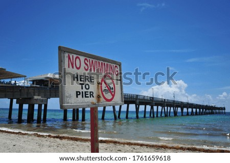 Beautiful Beach Sign in Tropical Beach with Pier