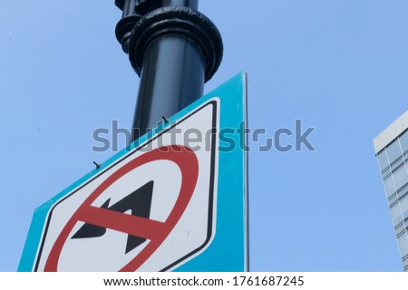 A low angle shot of a traffic sign warning "Don't turn Left"