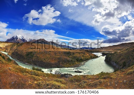 Travel to Chile. The river bends a horseshoe under the flying clouds. The picture was taken Fisheye lens 