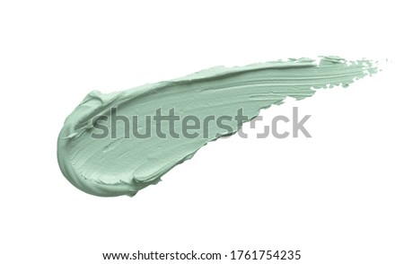 Green color correcting concealer smear smudge isolated on white background. Thick cream texture. Facial mask, skincare beauty product swatch closeup Royalty-Free Stock Photo #1761754235