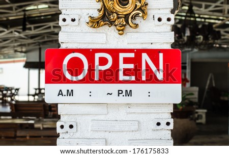 open sign hanging on a pole outside a restaurant, store, office or other