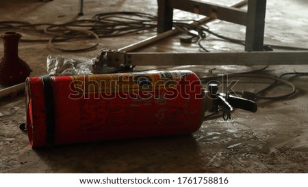 Old Fire Extinguisher after fire, useless fire extinguisher