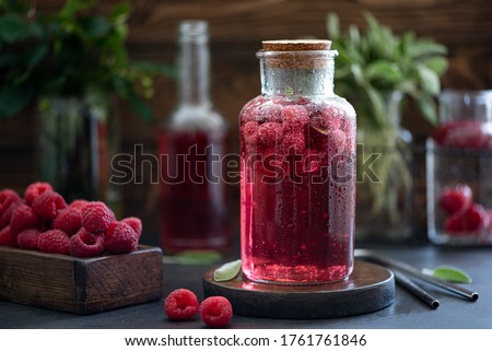 iced raspberry lemonade with sage and mint on a wooden table Royalty-Free Stock Photo #1761761846