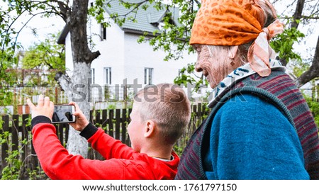 Happy grandmother and grandson taking selfie photo. concept of happy family, Video call in home garden, three generations, Multi-Generation
