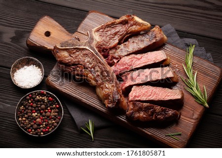 T-bone grilled beef steak with spices and herbs Royalty-Free Stock Photo #1761805871