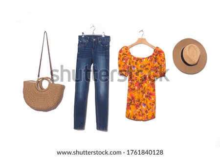 Fashion woman floral pattern dress on hanging with hat, shoes, handbag ,blue jeans on white background
