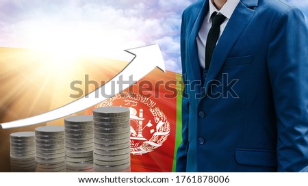 Business concept of increasing sales, Businessman on the background of the flag of Afghanistan and a graph of increasing up.
