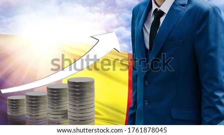 Business concept of increasing sales, Businessman on the background of the flag of Romania and a graph of increasing up.