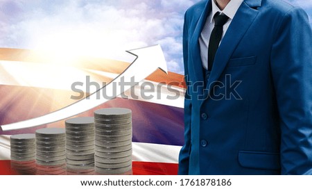 Business concept of increasing sales, Businessman on the background of the flag of Thailand and a graph of increasing up.