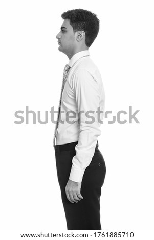 Profile view of young handsome Persian businessman