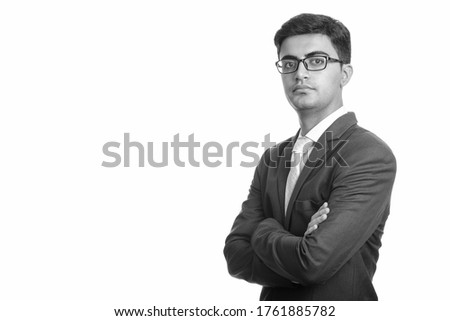 Portrait of young handsome Persian businessman wearing eyeglasses