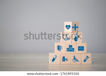 Health Insurance Concept,arranging wood block stacking with icon healthcare medical.