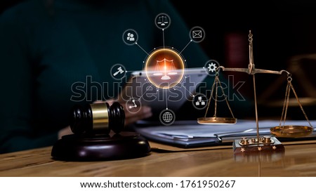 Law and Legal services concept, Good service cooperation, lawyer hands using tablet and working on wood table office. Soft focus.