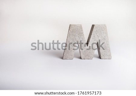 Concrete Capital Letter M isolated on white background. 3D object
