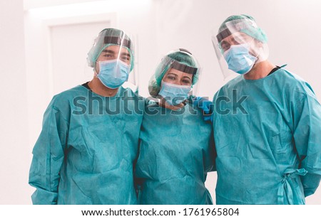 Medical workers inside hospital corridor during coronavirus pandemic outbreak - Doctor and nurse at work on Covid-19 crisis period - Health care concept - Main focus on center woman face Royalty-Free Stock Photo #1761965804