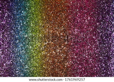 Texture of rainbow sparkles, close up, bright colorful texture