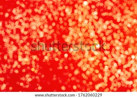 Golden Shine on red background. Bokeh pattern texture red color. 