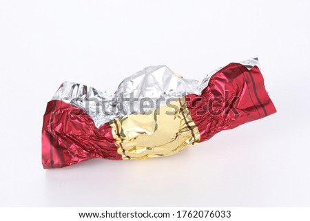 red and gold empty candy wrapper isolated on white background with copy space for your text Royalty-Free Stock Photo #1762076033