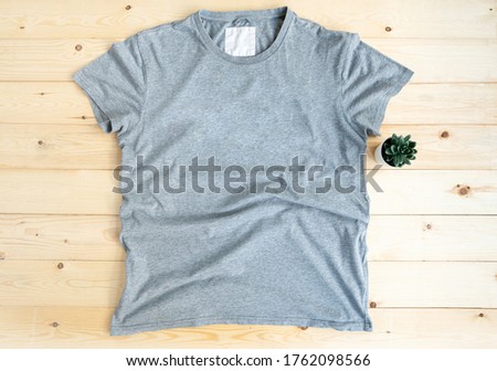 T-shirt mock up on wooden background,

