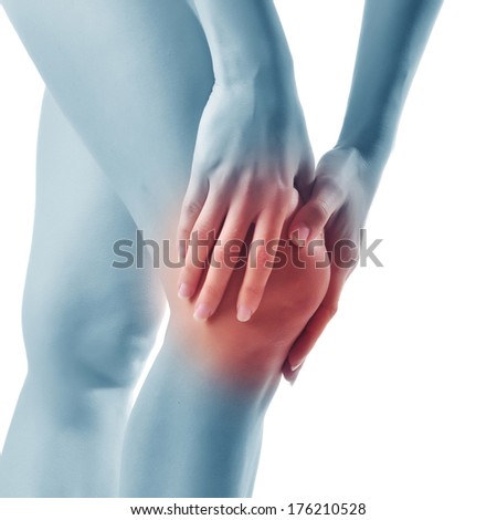 Acute pain in a woman knee. Female holding hand to spot of knee-aches