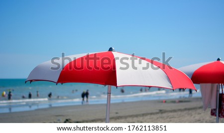 a beach umbrella open in front of the sea