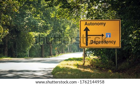Street Sign the Direction Way to Autonomy versus Dependency Royalty-Free Stock Photo #1762144958