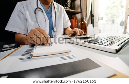 General Medical Services (GMS) and general practitioners (GPs or family physicians). Successful diagrams. Smart doctors make report notes (COVID-19). Royalty-Free Stock Photo #1762150151