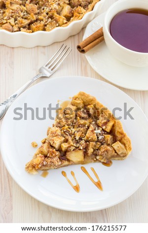 Slice of delicious fresh baked  apple pie on a wooden table