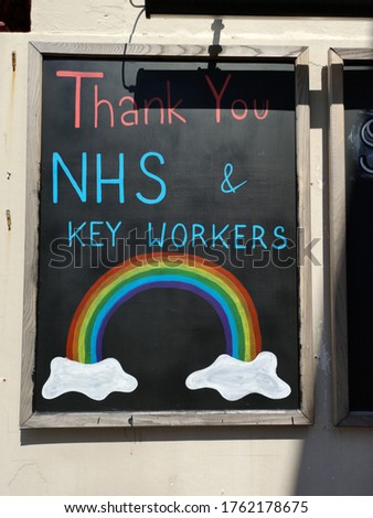A board on an external wall. Saying, thank you NHS & Key Workers with an image of a rainbow 