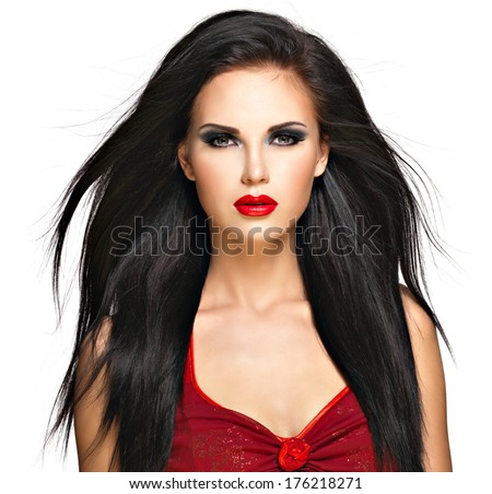 Portrait of  the beautiful woman with  black straight hairs and red lips, evening makeup. Pretty model posing at studio