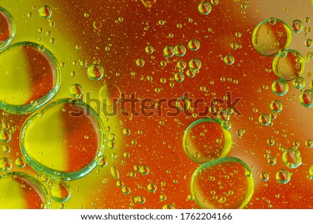 Abstract bubbles background - oil in water on a blurred background in yellow red tones