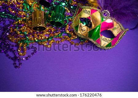 Festive Grouping of mardi gras, venetian or carnivale mask on a purple background Royalty-Free Stock Photo #176220476
