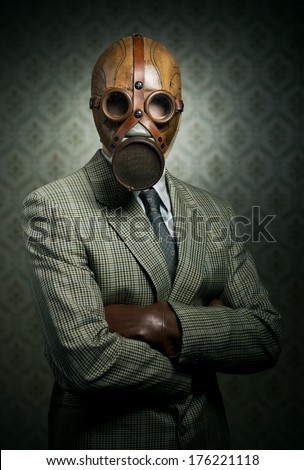 Vintage businessman wearing a gas mask with retro wallpaper on background. Royalty-Free Stock Photo #176221118