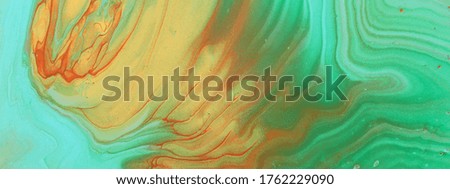 art photography of abstract marbleized effect background. Turquoise, green, gold and blue creative colors. Beautiful paint