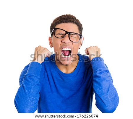 Closeup portrait of frustrated, mad angry nerdy young man with big glasses, screaming fists raised, isolated on white background. Negative emotions facial expressions feelings, body language
