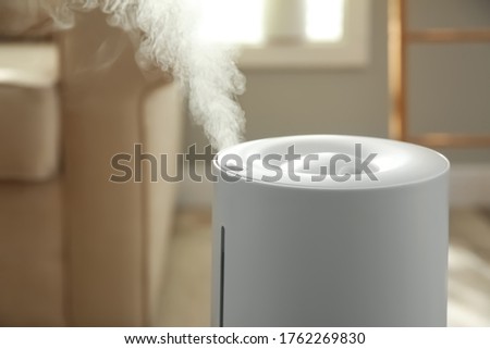 Modern air humidifier at home, closeup view Royalty-Free Stock Photo #1762269830
