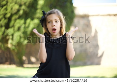 Surprise concept. Portrait of astonished beautiful girl looking surprised in full disbelief wide open mouth with hands near face with braided hair. Positive emotion facial expression body language.