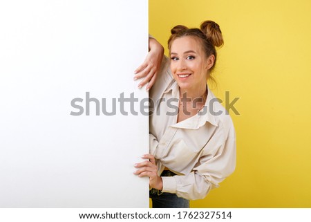 Girl smiles with white banner on yellow background