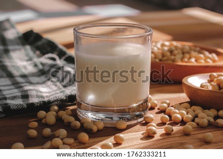 soy milk and soybeans on a wooden table