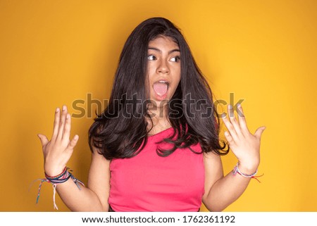 photo of freaked spoiled girl on yellow background
